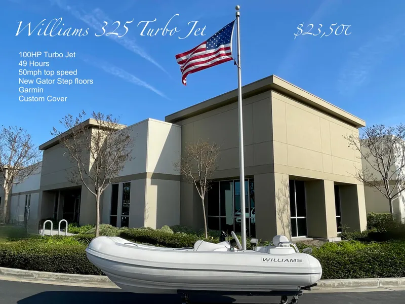 Slide: The Image of 2011 Williams Jet Tenders 325 Turbo Jet boat displayed outside modern building. - 1