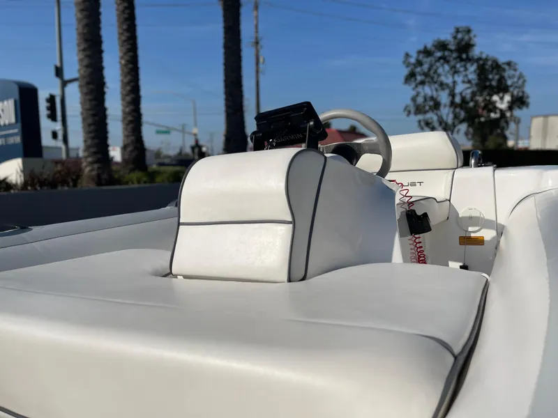 Slide: The Image of 2011 Williams Jet Tenders 325 Turbo Jet with white seating and steering wheel, outdoors. - 14