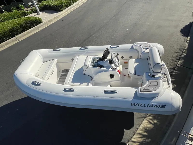 Slide: The Image of 2011 Williams Jet Tenders 325 Turbo Jet inflatable boat on pavement. - 2