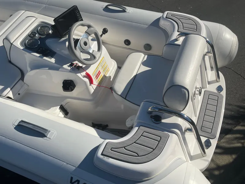 Slide: The Image of 2011 Williams Jet Tenders 325 Turbo Jet, white interior, steering wheel, and seating area. - 5