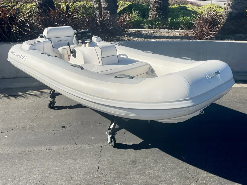 Slide: The Image of 2011 Williams Jet Tenders 325 Turbo Jet inflatable boat on pavement. - 6