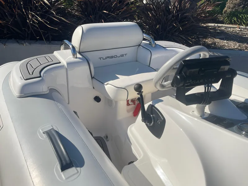 Slide: The Image of 2011 Williams Jet Tenders 325 Turbo Jet interior with steering wheel and seating. - 7