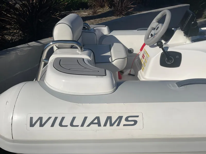 Slide: The Image of 2011 Williams Jet Tenders 325 Turbo Jet boat interior with steering wheel and seating. - 8