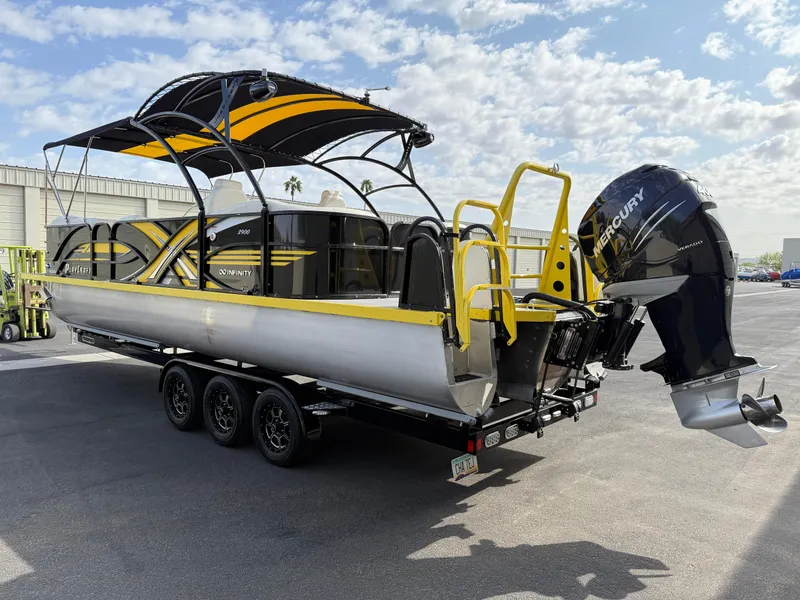Slide: The Image of 2021 PlayCraft Infinity 2900 pontoon boat with Mercury outboard engine on a trailer. - 12