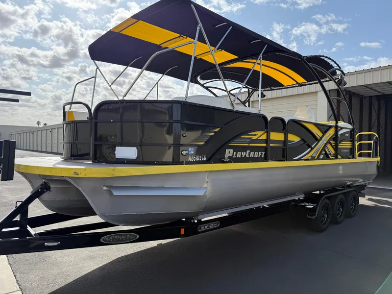 Slide: The Image of 2021 PlayCraft Infinity 2900 pontoon boat with yellow and black canopy on trailer. - 15