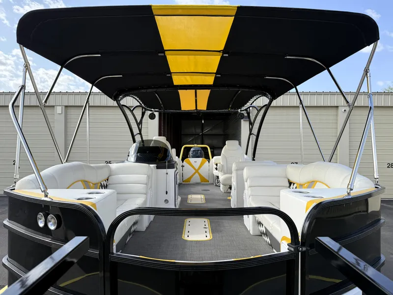 Slide: The Image of 2021 PlayCraft Infinity 2900 pontoon boat with black and yellow canopy, luxurious seating. - 16