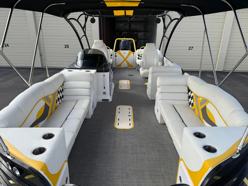 Slide: The Image of 2021 PlayCraft Infinity 2900 boat interior with white and yellow seating, cup holders, and modern design. - 17