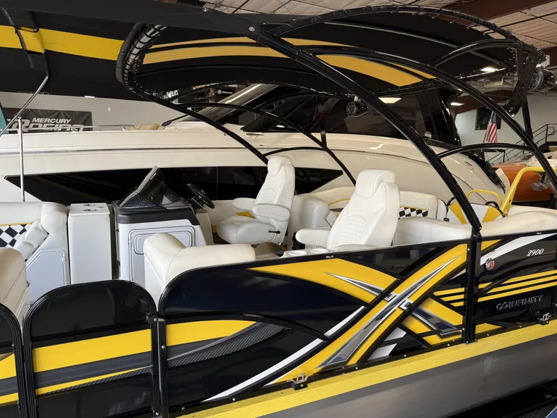Slide: The Image of 2021 PlayCraft Infinity 2900 boat with sleek yellow and black design, luxurious seating. - 21