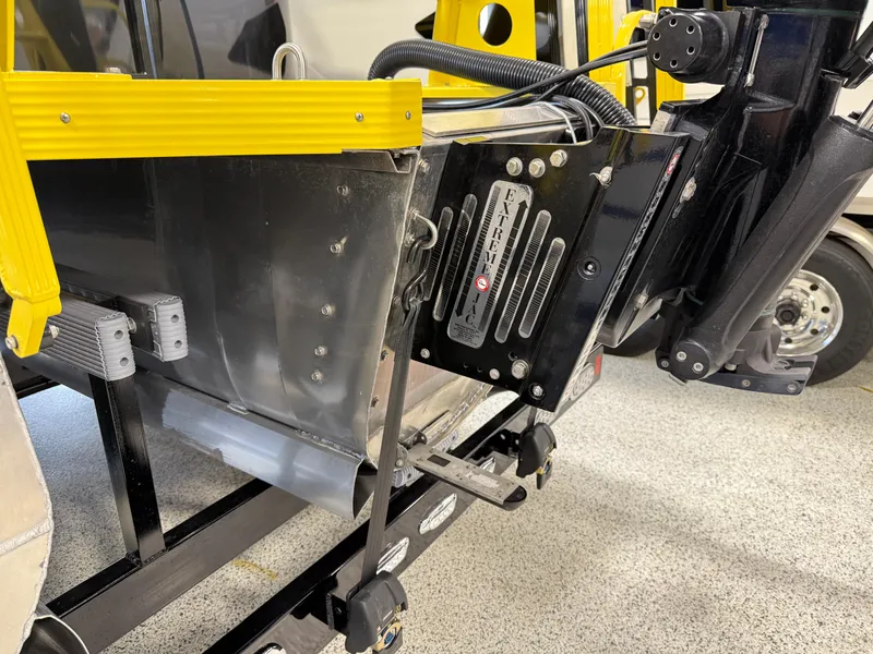 Slide: The Image of 2021 PlayCraft Infinity 2900 boat engine mount and transom detail in a garage setting. - 24