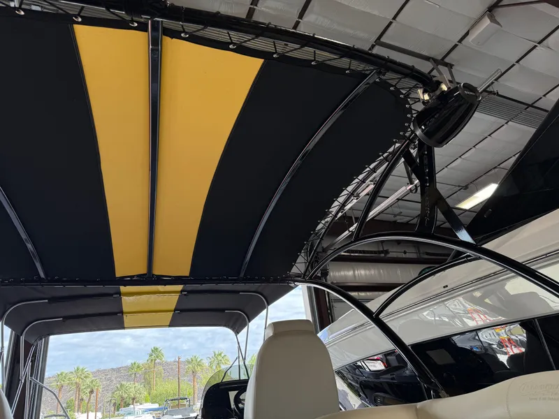 Slide: The Image of 2021 PlayCraft Infinity 2900 boat with black and yellow canopy, indoor storage. - 29