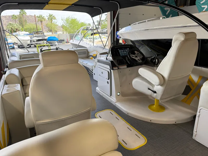 Slide: The Image of Interior of a 2021 PlayCraft Infinity 2900 boat with white seating and modern dashboard. - 31