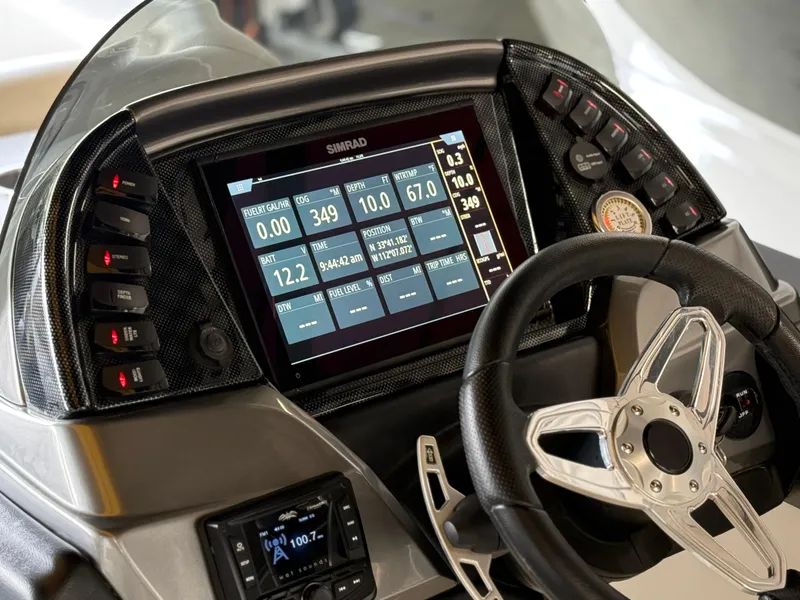 Slide: The Image of Dashboard of 2021 PlayCraft Infinity 2900 boat with digital display and steering wheel. - 32
