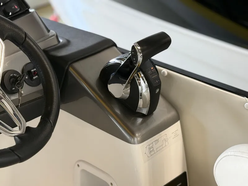 Slide: The Image of Throttle control of 2021 PlayCraft Infinity 2900 boat, featuring sleek design and ergonomic handle. - 33