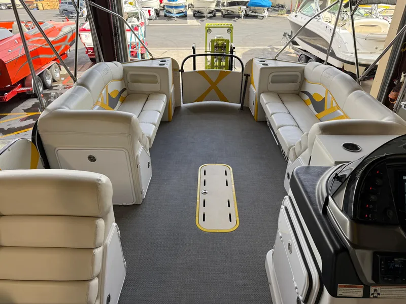 Slide: The Image of 2021 PlayCraft Infinity 2900 boat interior with white seating and modern dashboard. - 38