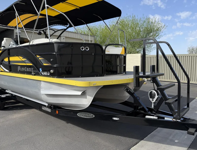 Slide: The Image of 2021 PlayCraft Infinity 2900 pontoon boat on trailer, featuring black and yellow design. - 4