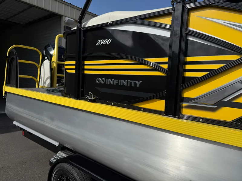 Slide: The Image of 2021 PlayCraft Infinity 2900 boat with yellow and black design on a trailer. - 6