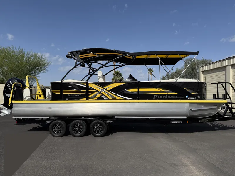 Slide: The Image of 2021 PlayCraft Infinity 2900 pontoon boat on trailer, featuring sleek black and yellow design. - 7