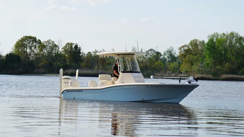 The Image of 2024 Grady-White 231 Coastal Explorer boat cruising on a calm lake. - 0
