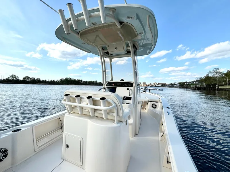 Slide: The Image of 2024 Grady-White 231 Coastal Explorer boat on calm water under blue sky. - 11