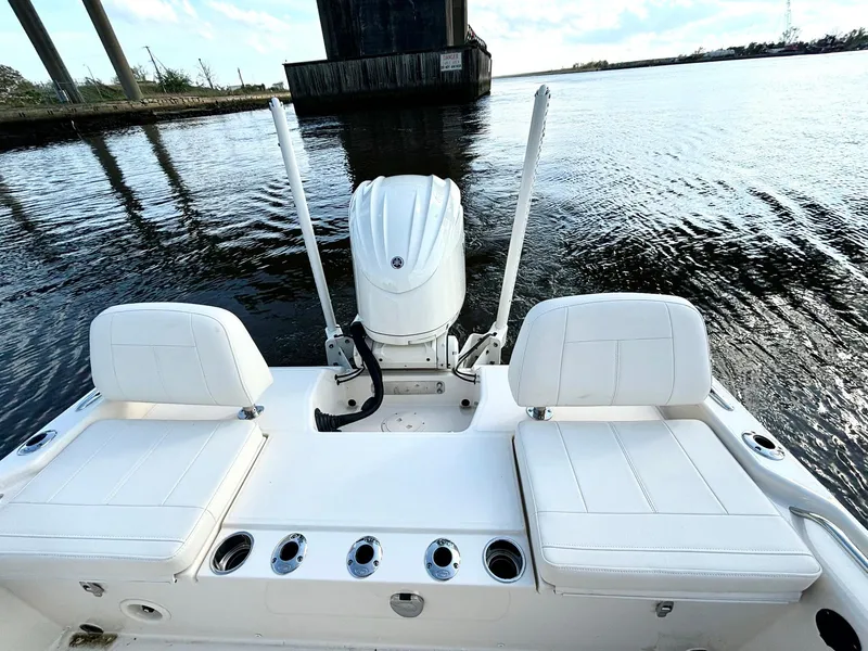 Slide: The Image of 2024 Grady-White 231 Coastal Explorer boat, rear view, on calm water. - 13
