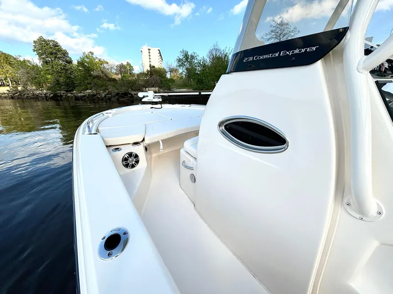 Slide: The Image of 2024 Grady-White 231 Coastal Explorer boat on calm water, showcasing sleek design and modern features. - 14