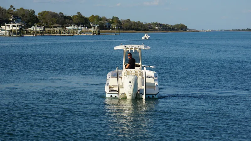Slide: The Image of 2024 Grady-White 231 Coastal Explorer boat cruising on a calm waterway. - 3