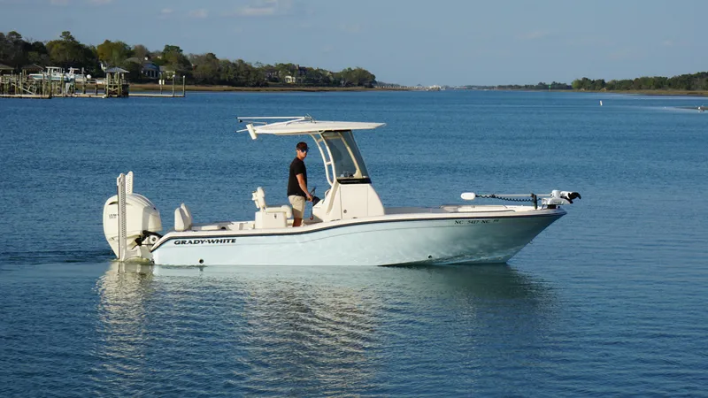 Slide: The Image of 2024 Grady-White 231 Coastal Explorer boat cruising on calm blue waters. - 5