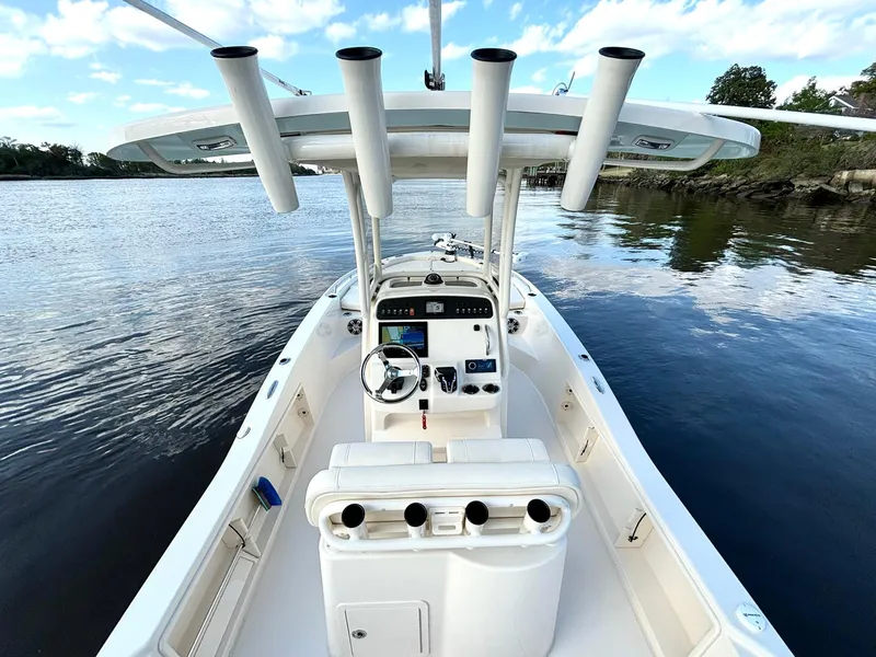 Slide: The Image of 2024 Grady-White 231 Coastal Explorer boat on calm water, featuring a sleek console design. - 8