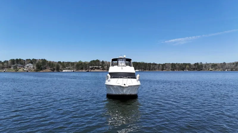 Slide: The Image of 2007 Silverton 36 Convertible boat on a calm lake under clear blue sky. - 10