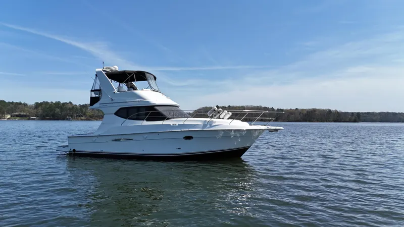 Slide: The Image of 2007 Silverton 36 Convertible yacht on calm water under clear blue sky. - 12
