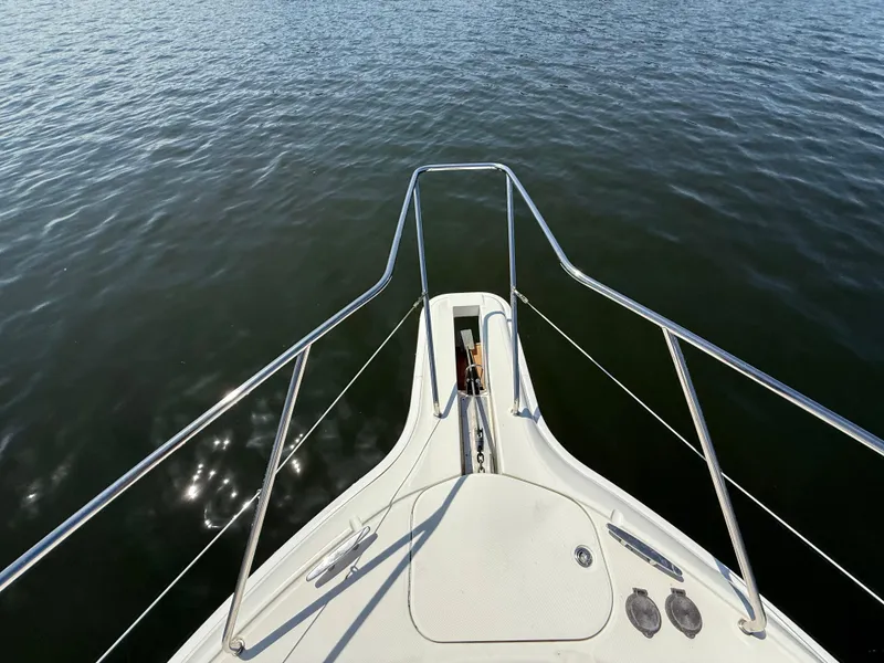 Slide: The Image of Bow view of 2007 Silverton 36 Convertible yacht on calm water. - 14
