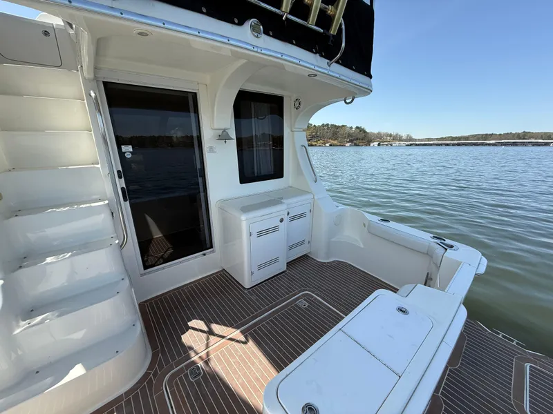 Slide: The Image of 2007 Silverton 36 Convertible yacht deck with lake view and sleek design. - 16