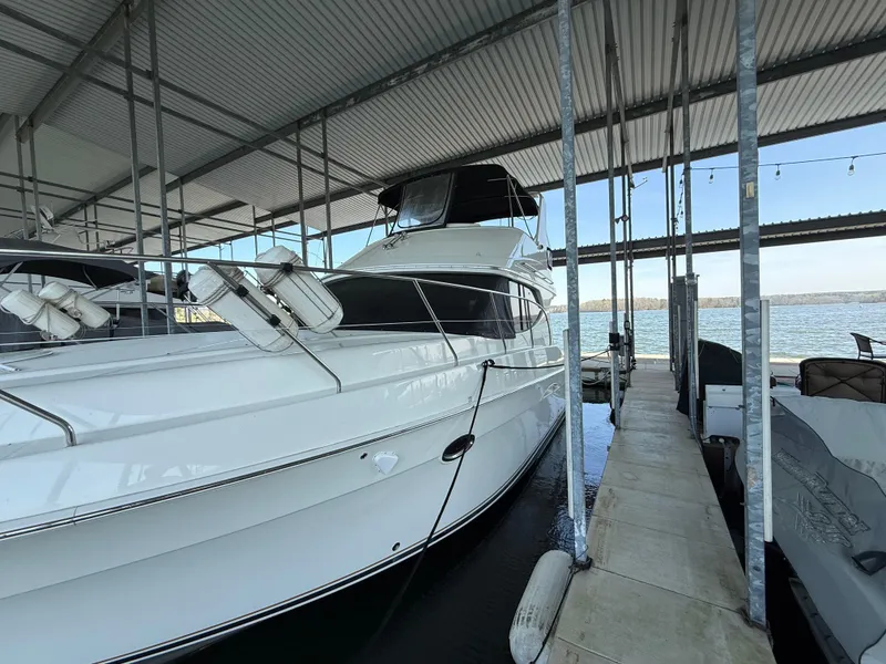 Slide: The Image of 2007 Silverton 36 Convertible yacht docked in a covered marina. - 17