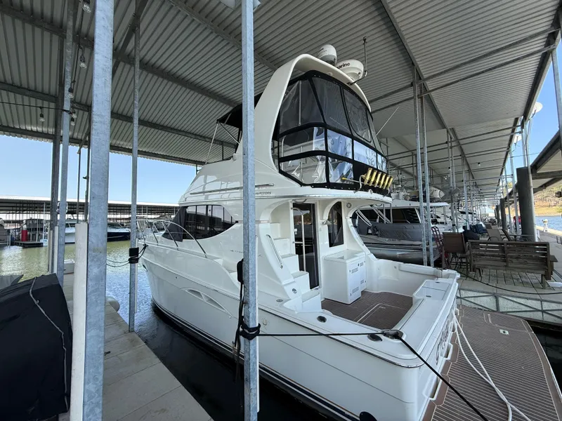 Slide: The Image of 2007 Silverton 36 Convertible yacht docked under a covered marina. - 18
