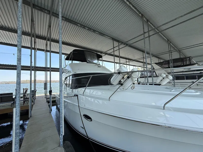 Slide: The Image of 2007 Silverton 36 Convertible yacht docked in a covered marina. - 19