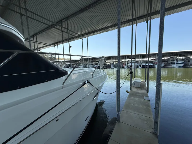 Slide: The Image of 2007 Silverton 36 Convertible yacht docked in a marina under a covered shelter. - 21