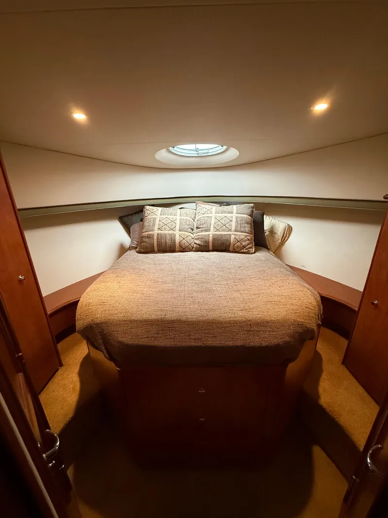 Slide: The Image of 2007 Silverton 36 Convertible cabin interior with cozy bed and ambient lighting. - 27