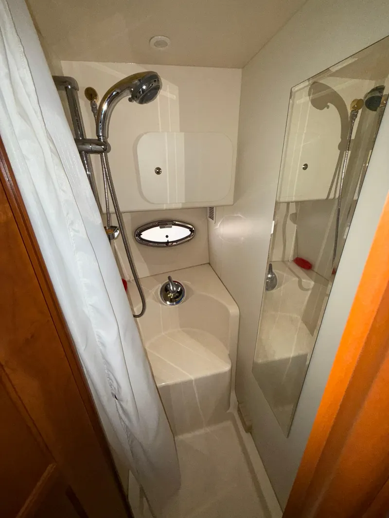Slide: The Image of 2007 Silverton 36 Convertible yacht bathroom with shower and mirror. - 29