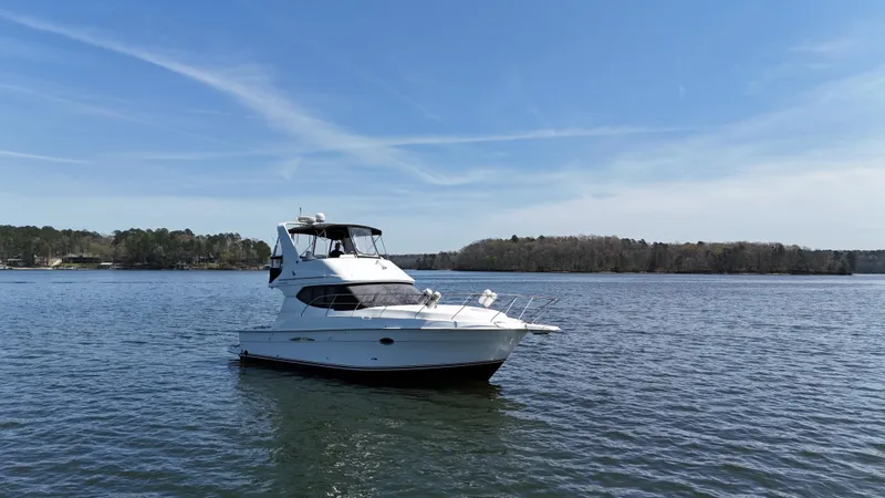 The Image of 2007 Silverton 36 Convertible yacht on calm water under clear blue sky. - 3