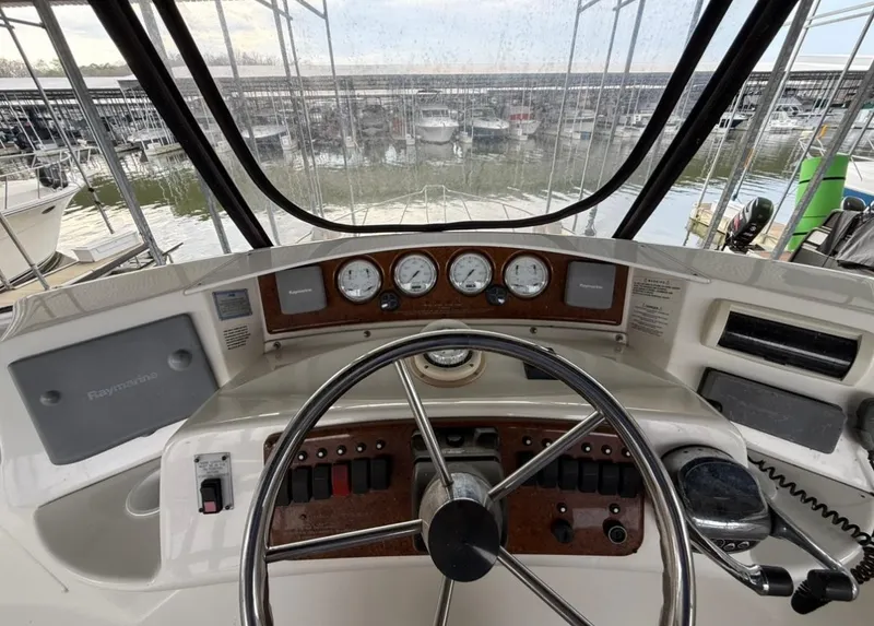 Slide: The Image of 2007 Silverton 36 Convertible boat helm with gauges and steering wheel, docked at marina. - 35