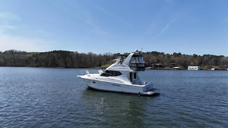 Slide: The Image of 2007 Silverton 36 Convertible yacht on a serene lake with wooded shoreline. - 8