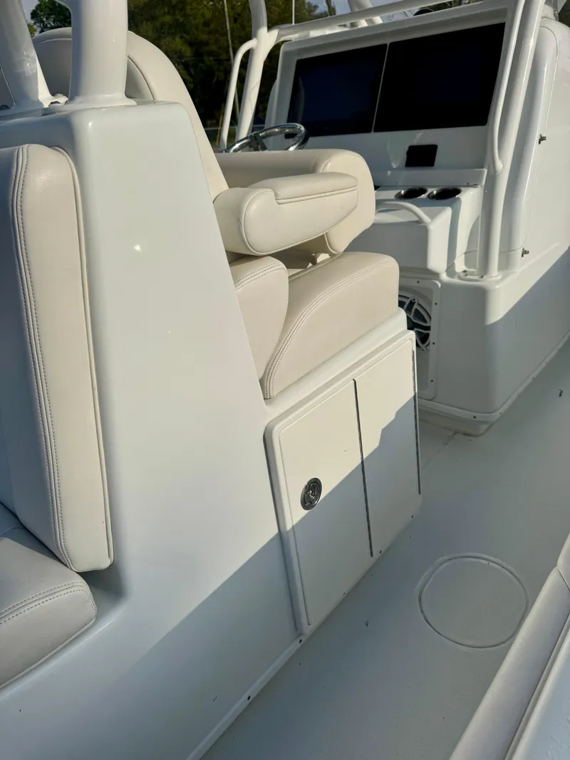 Slide: The Image of 2022 Yellowfin 36 Open boat interior with white seating and modern dashboard. - 10