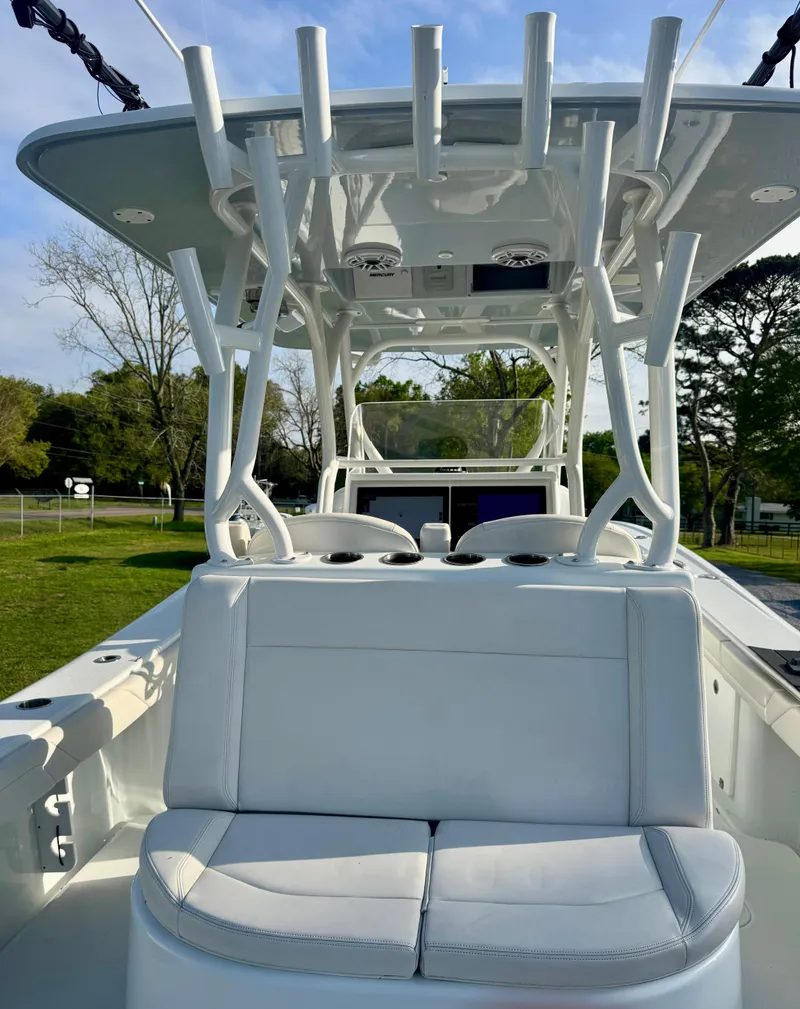 Slide: The Image of 2022 Yellowfin 36 Open boat with sleek seating and rod holders, docked outdoors. - 12