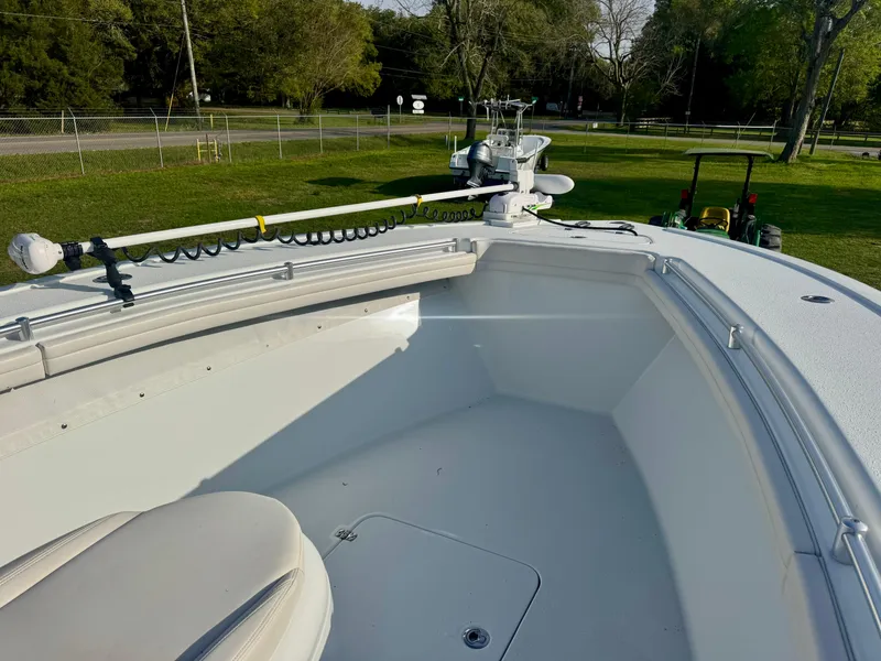 Slide: The Image of 2022 Yellowfin 36 Open boat, spacious deck, white interior, parked on grass. - 13