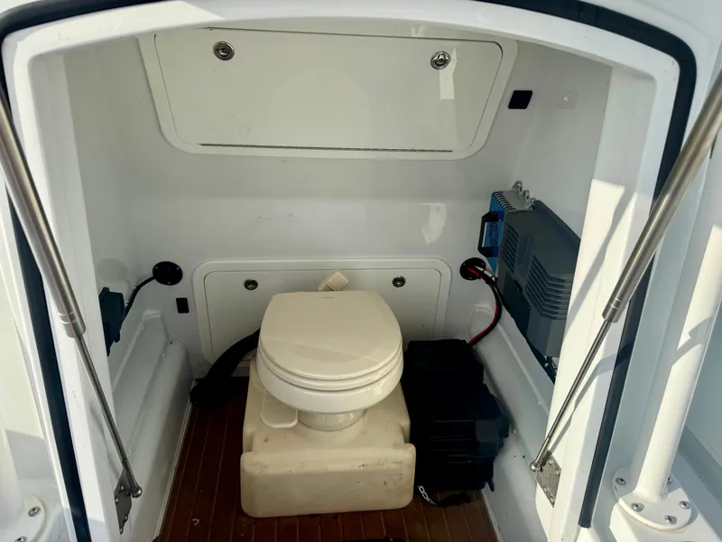 Slide: The Image of 2022 Yellowfin 36 Open boat interior with toilet and storage compartments. - 15