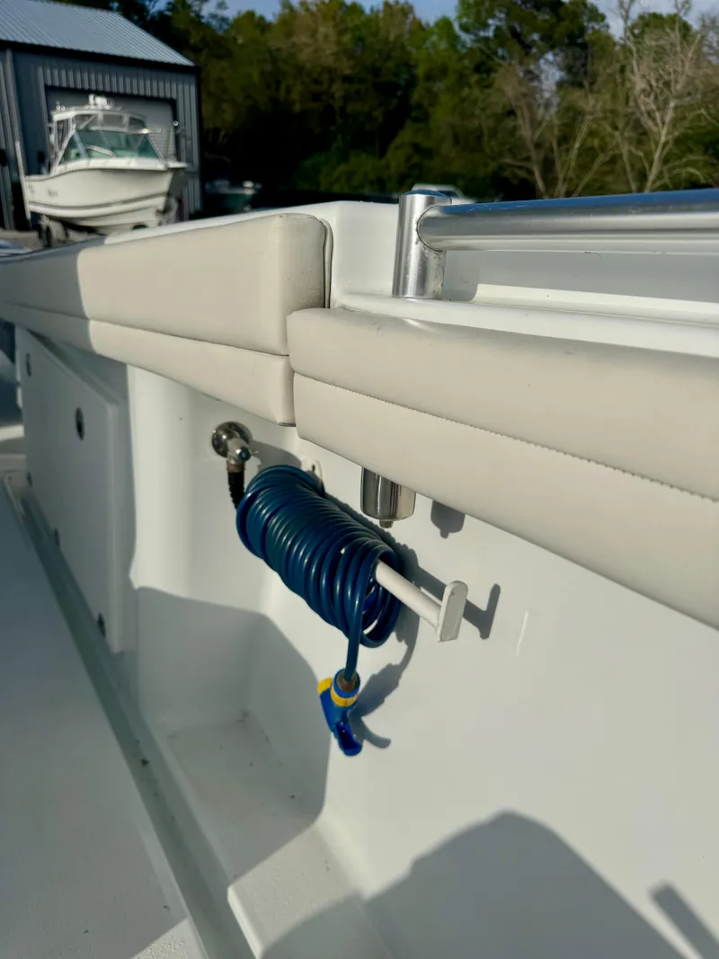 Slide: The Image of 2022 Yellowfin 36 Open boat interior with coiled blue hose and cushioned seating. - 18