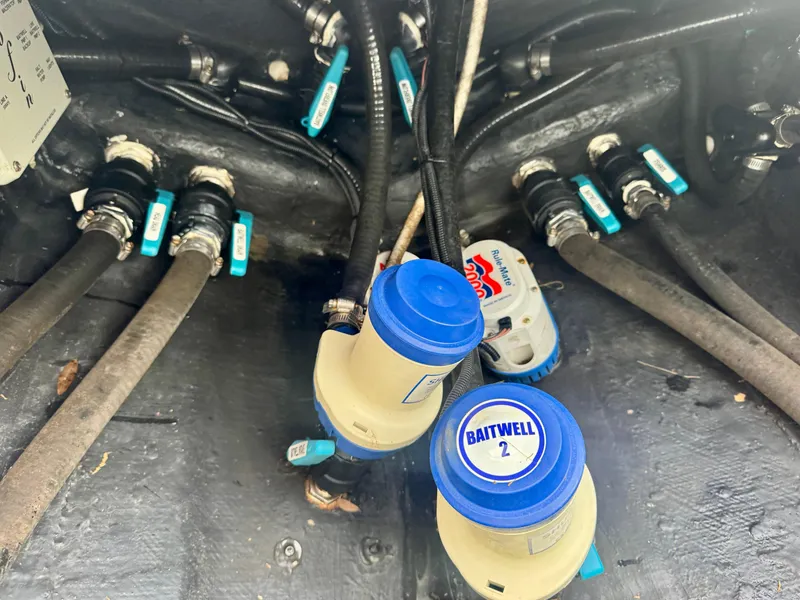 Slide: The Image of Bilge area of 2022 Yellowfin 36 Open boat with hoses and valves visible. - 22