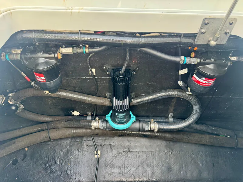 Slide: The Image of 2022 Yellowfin 36 Open boat plumbing system with hoses and filters. - 24