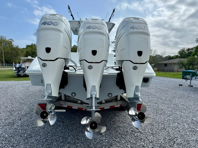 Slide: The Image of 2022 Yellowfin 36 Open boat with triple 400 horsepower engines on a gravel lot. - 5