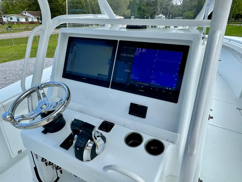Slide: The Image of 2022 Yellowfin 36 Open boat console with dual screens and steering wheel. - 6